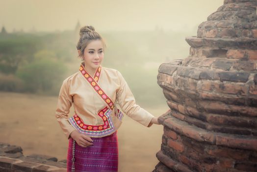 Beautiful girl in Myanmar traditional costume,  identity culture of Myanmar, Pagdodas of Bagan Background, Happy asian woman
