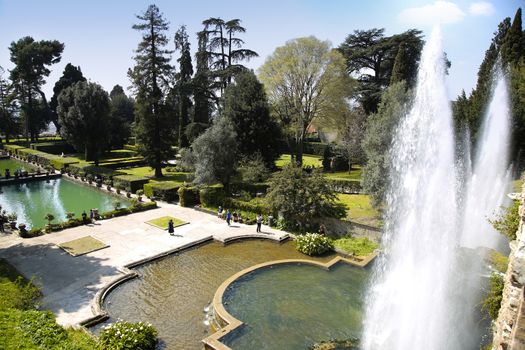 TIVOLI, ITALY - APRIL 10, 2015: Tourists visiting Fountain of Neptune and Organ in Villa d'Este in Tivoli. Villa d`Este fountain and garden in Tivoli near Roma, Italy on April 10, 2015.