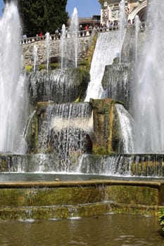 TIVOLI, ITALY - APRIL 10, 2015: Tourists visiting Fountain of Neptune and Organ in Villa d'Este in Tivoli. Villa d`Este fountain and garden in Tivoli near Roma, Italy on April 10, 2015.