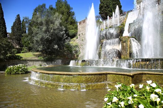 TIVOLI, ITALY - APRIL 10, 2015: Tourists visiting Fountain of Neptune and Organ in Villa d'Este in Tivoli. Villa d`Este fountain and garden in Tivoli near Roma, Italy on April 10, 2015.