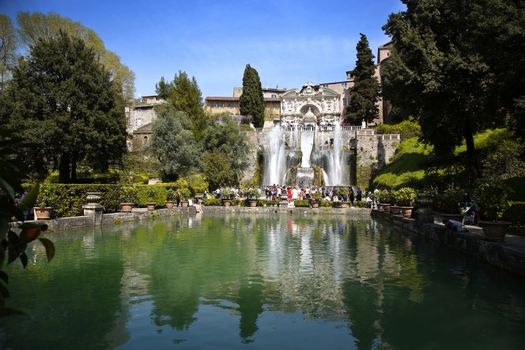 TIVOLI, ITALY - APRIL 10, 2015: Tourists visiting Fountain of Neptune and Organ in Villa d'Este in Tivoli. Villa d`Este fountain and garden in Tivoli near Roma, Italy on April 10, 2015.