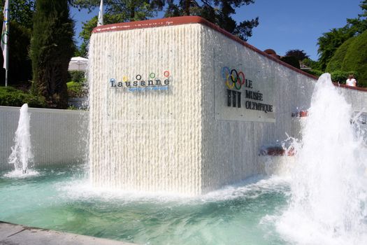 LAUSANNE, SWITZERLAND - MAY 24, 2010: Fountain and Signboard at Olympic museum in Lausanne, Switzerland on Lake Geneva. Here is Olympic museum which is the largest archive of Olympic Games in the world.