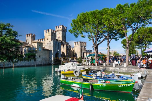 Sirmione, province of Brescia, Lombardy, northern Italy, 15th August 2016: people visiting the medieval castle Scaliger on lake Lago di Garda