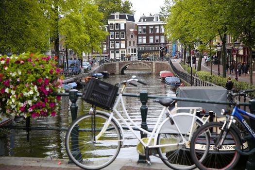 AMSTERDAM, THE NETHERLANDS - AUGUST 18, 2015: View on Prinsengracht from Lijnbaansgracht. Street life, Canal, bicycle and boat in Amsterdam. Amsterdam is capital of the Netherlands on August 18, 2015.