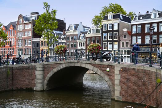 AMSTERDAM, THE NETHERLANDS - AUGUST 18, 2015: View on Prinsengracht from Spiegelgracht. Street life, Canal, pedestrians and bicycle in Amsterdam. Amsterdam is capital of the Netherlands on August 18, 2015.