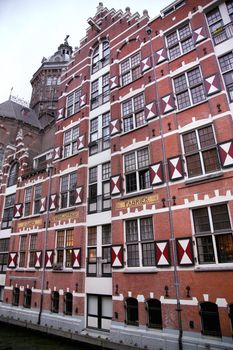 AMSTERDAM; THE NETHERLANDS - AUGUST 18; 2015: View on Oudezijds Kolk canal in Amsterdam, building Verf en Vernis Fabriek H.Vettewinke in Amsterdam. Amsterdam is capital of the Netherlands on August 18; 2015.