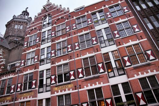 AMSTERDAM; THE NETHERLANDS - AUGUST 18; 2015: View on Oudezijds Kolk canal in Amsterdam, building Verf en Vernis Fabriek H.Vettewinke in Amsterdam. Amsterdam is capital of the Netherlands on August 18; 2015.