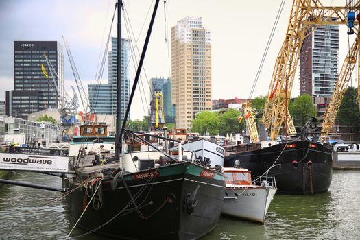 ROTTERDAM, THE NETHERLANDS - 18 AUGUST: Old cranes in Historical Leuvehaven, Rotterdam's oldest sea port. Harbor and modern apartment buildings in Rotterdam, Netherlands on August 18,2015.