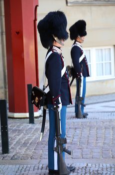 COPENHAGEN, DENMARK - AUGUST 15, 2016: Danish Royal Life Guards on the central plaza of Amalienborg palace, home of the Danish Royal family in Copenhagen, Denmark on August 15, 2016.