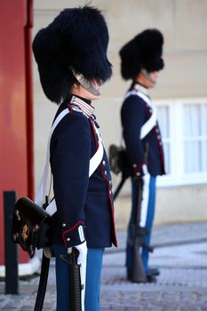 COPENHAGEN, DENMARK - AUGUST 15, 2016: Danish Royal Life Guards on the central plaza of Amalienborg palace, home of the Danish Royal family in Copenhagen, Denmark on August 15, 2016.