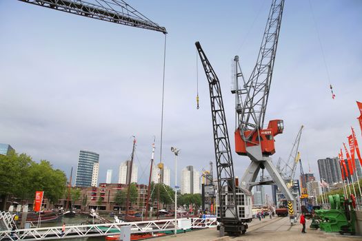 ROTTERDAM, THE NETHERLANDS - 18 AUGUST: People around Maritime Museum in Historical Leuvehaven, Rotterdam's oldest sea port. Harbor and modern apartment buildings in Rotterdam, Netherlands on August 18,2015.