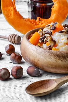 Traditional Russian dish, pumpkin porridge in wooden bowl