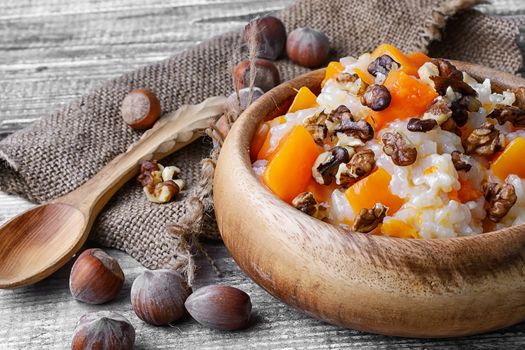 Traditional Russian dish, pumpkin porridge in wooden bowl