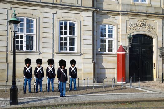 COPENHAGEN, DENMARK - AUGUST 15, 2016: Danish Royal Life Guards on the central plaza of Amalienborg palace, home of the Danish Royal family in Copenhagen, Denmark on August 15, 2016.