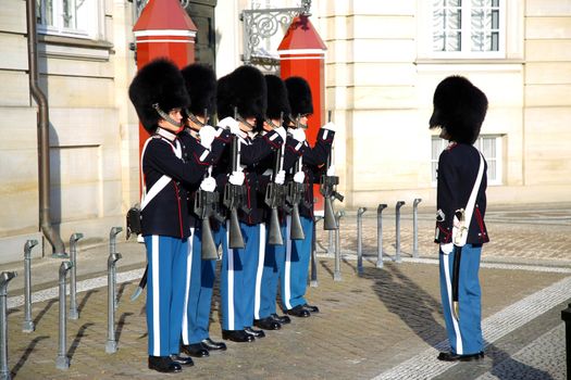 COPENHAGEN, DENMARK - AUGUST 15, 2016: Danish Royal Life Guards on the central plaza of Amalienborg palace, home of the Danish Royal family in Copenhagen, Denmark on August 15, 2016.