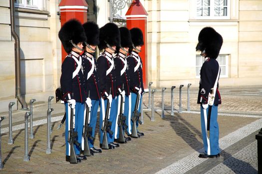 COPENHAGEN, DENMARK - AUGUST 15, 2016: Danish Royal Life Guards on the central plaza of Amalienborg palace, home of the Danish Royal family in Copenhagen, Denmark on August 15, 2016.