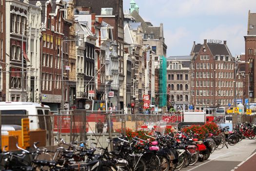 AMSTERDAM, THE NETHERLANDS - AUGUST 19, 2015: Rokin street with row of shops; restaurants and Dam Square, Street life, shops, restaurants,tourists and bicycle iin Amsterdam. Amsterdam is capital of the Netherlands on August 19, 2015.