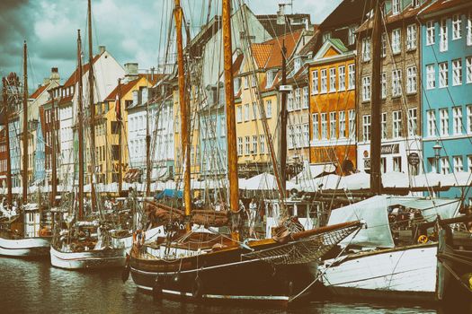 COPENHAGEN, DENMARK - AUGUST 14, 2016: Boats in the docks Nyhavn, people, restaurants and colorful architecture. Nyhavn a 17th century harbour in Copenhagen, Denmark on August 14, 2016.