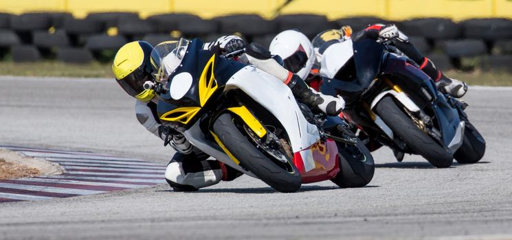 Two racing motorcycles on a sharp bend