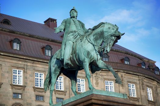 The equestrian statue of King Frederik VII in front of the Christiansborg Palace in Copenhagen, Denmark