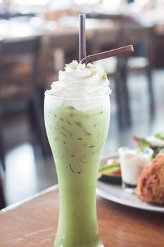 Iced green tea with whipped cream, stock photo