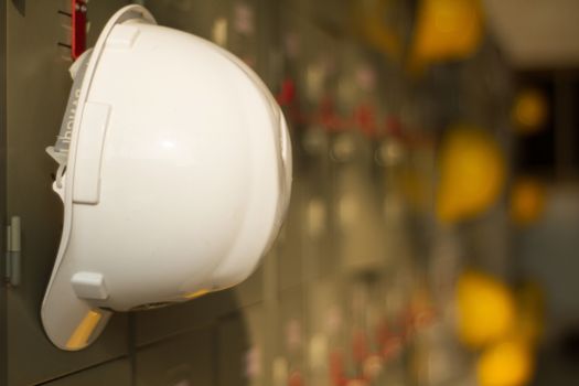 Safety helmet hanging on locker for worker equipment