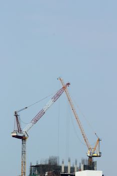 Construction of building with tower cranes against sky