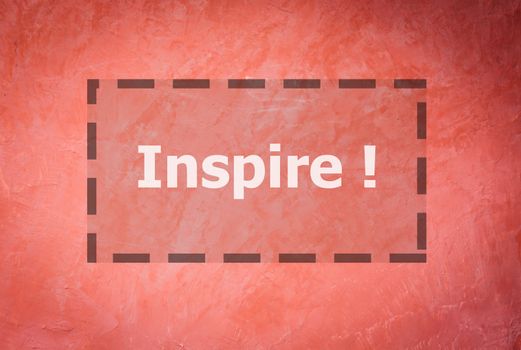 Inspire word inspirational quote on handmade creative red wall background