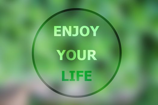 Enjoy your life inspirational quote on blurred background