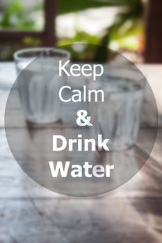 Keep calm and drink water inspirational quote on blurred background