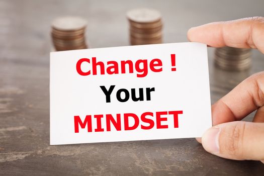 Change your mindset inspirational quote on name card with coins