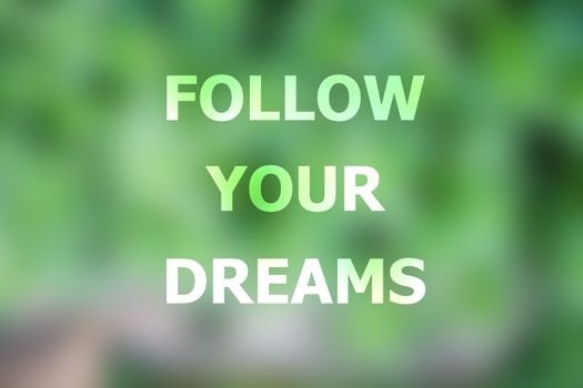 Follow your dreams inspirational quote on blurred background