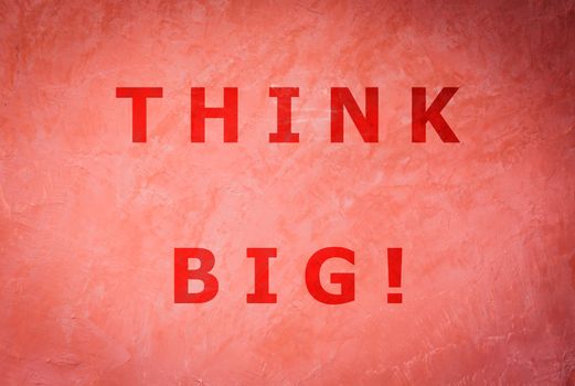 Think big word inspirational quote on handmade creative red wall background