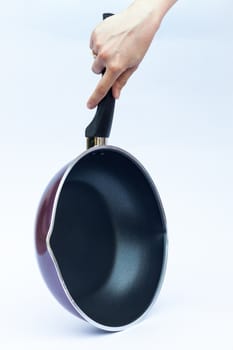 Hand with non stick frying pan on white background, stock photo