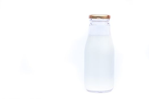 Traditional glass milk bottle on white background, stock photo