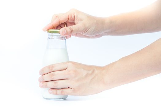 Woman hand open traditional glass milk bottle, stock photo