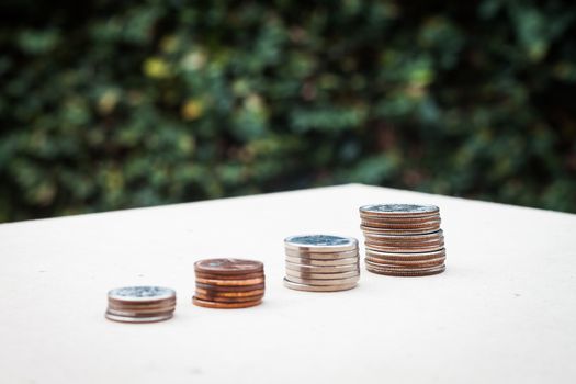 Money coin growing graph with green background, stock photo