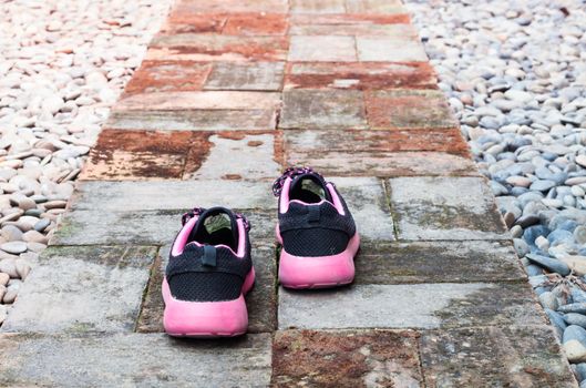 Running shoes in home garden foot path, stock photo