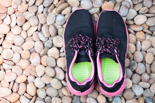 Running shoes in home garden on pebbles, stock photo