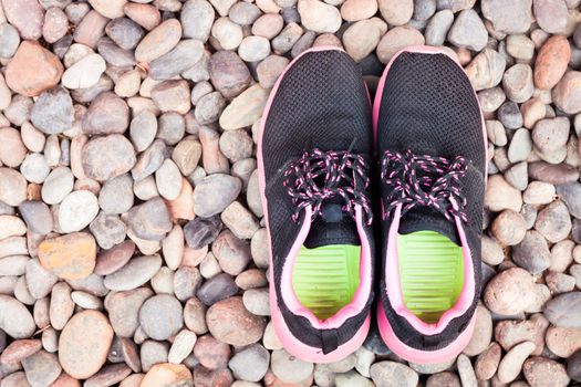 Running shoes in home garden on pebbles, stock photo