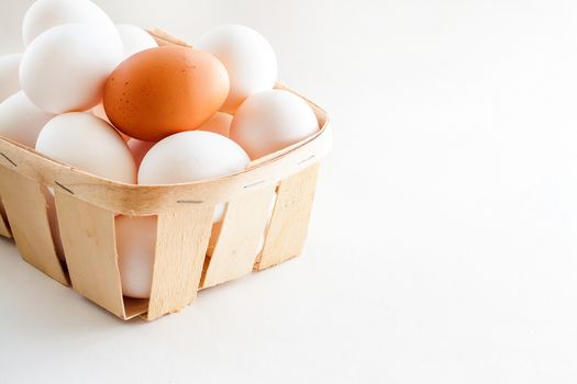 full basket of fresh eggs on a white background/