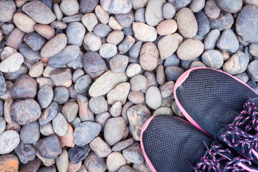 Running shoes in home garden on pebbles, stock photo