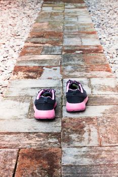 Running shoes in home garden foot path, stock photo