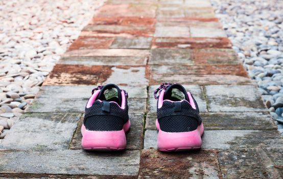 Running shoes in home garden foot path, stock photo