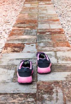 Running shoes in home garden foot path, stock photo