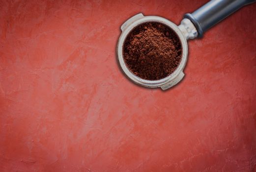 Coffee grind in group on red concrete background, stock photo