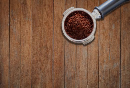 Coffee grind in group on wooden background, stock photo