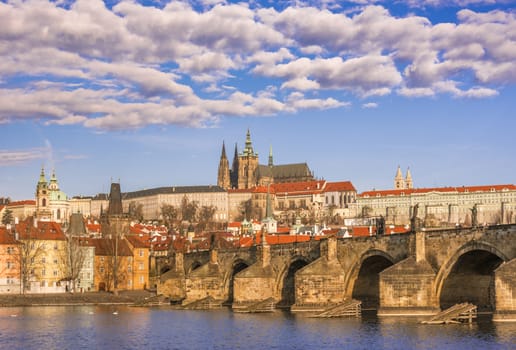 Cityscape with St. Vitus Cathedral in background and the Charles Bridge in foreground, under a beautiful sky. Picture captured in Prague, Czech Republic