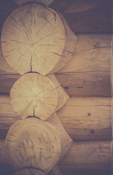 Rustic image with details of a wooden cabin corner, with logs joined together with a great construction technique.