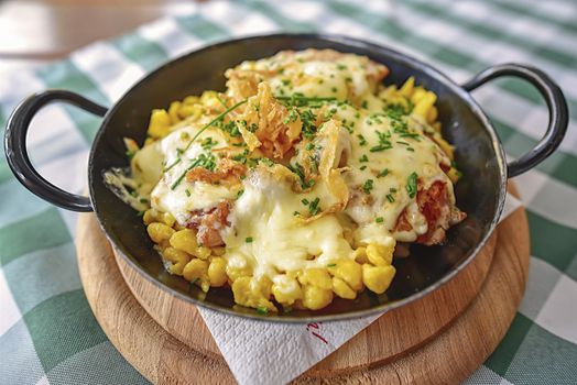 Close-up image with a traditional german meal, called "Bergpfandl", specific to the Berchtesgaden Alps area, Bavaria. It is a delicious dish, consisting from fillet of pork with spaetzle and fresh mushrooms, gratinated with cheese.